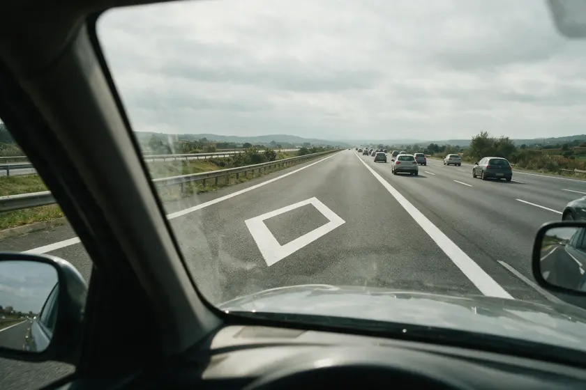 Autovía con un carril reservado a la izquierda, separado por cebreado y con el rombo pintado en el pavimento